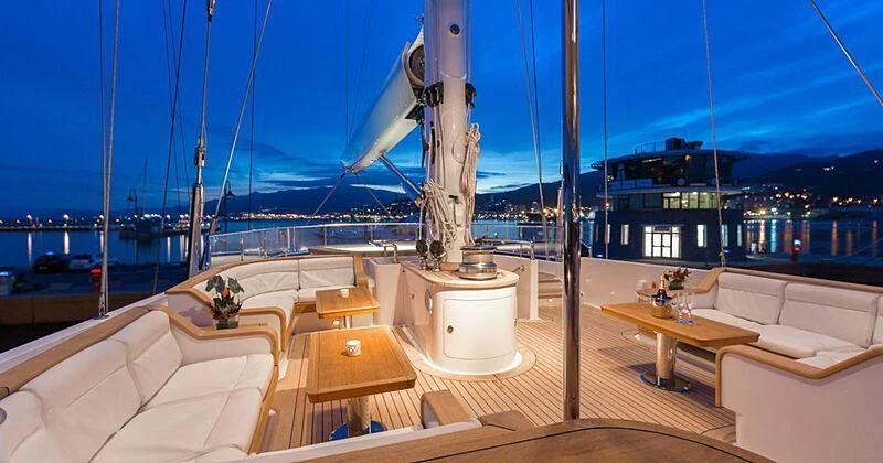 a room with a table and chairs aboard BURRASCA Yacht for Sale