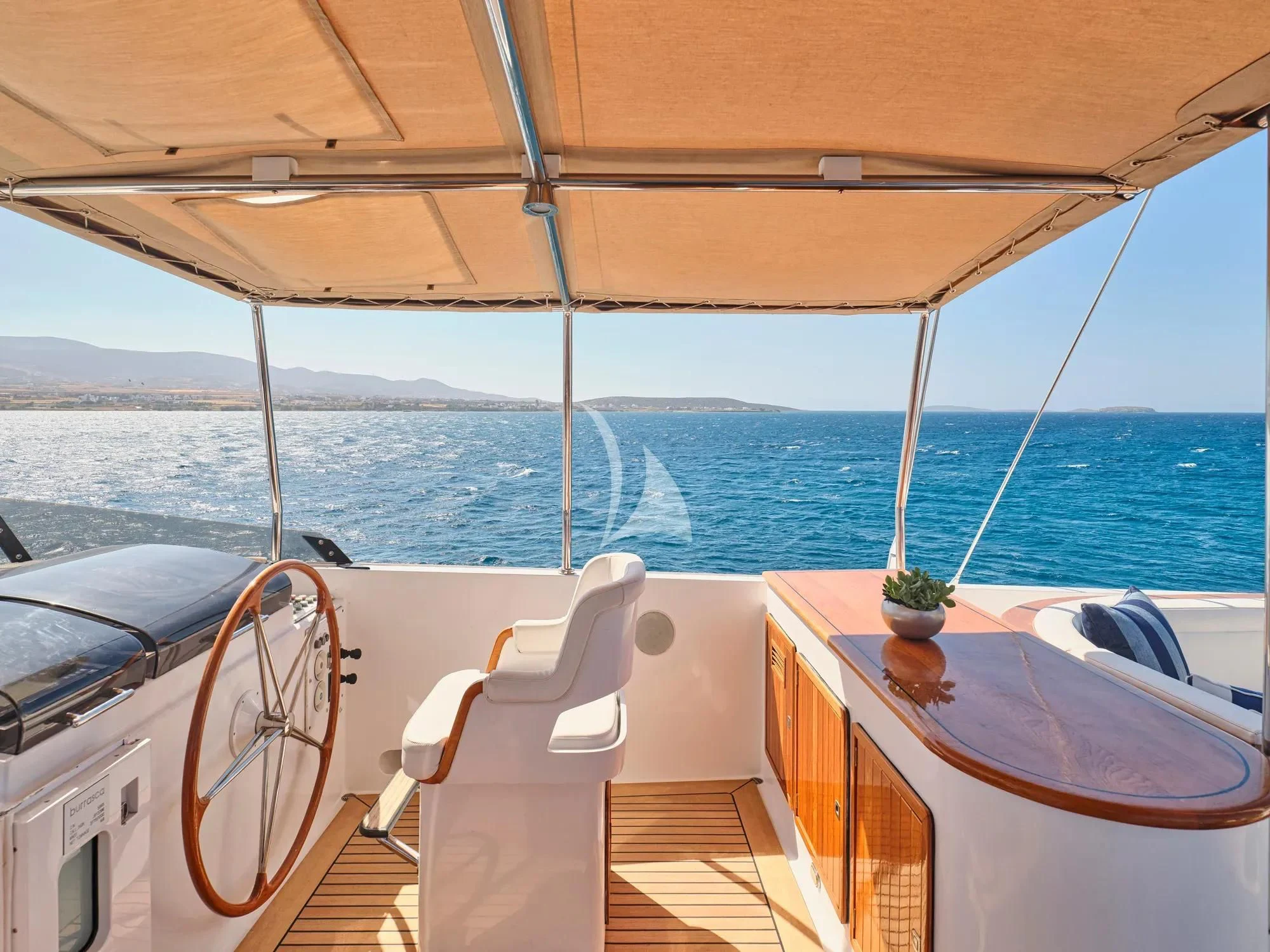 a boat with a table and chairs on it aboard BURRASCA Yacht for Sale