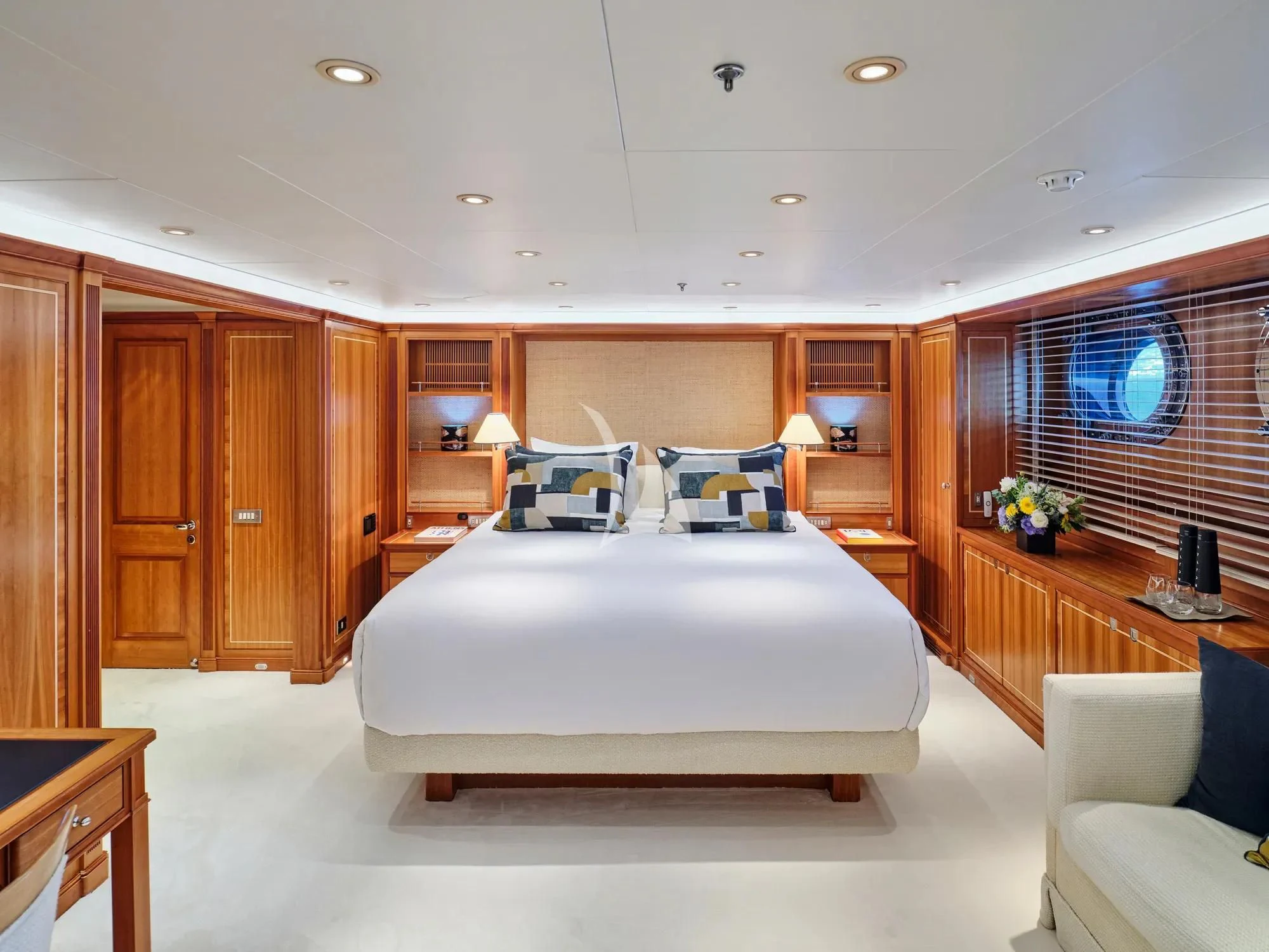 a bedroom with a bed and a desk aboard BURRASCA Yacht for Sale
