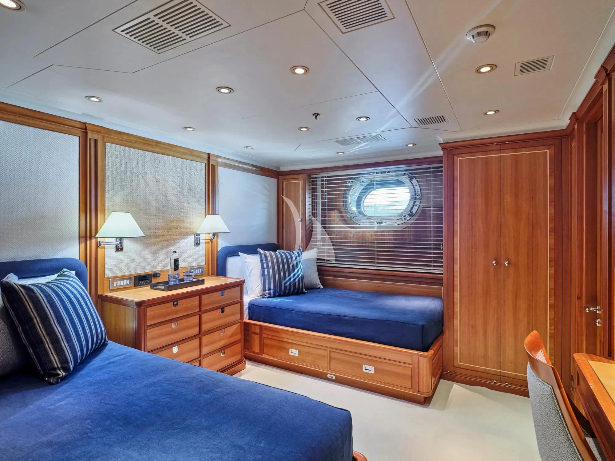 a bedroom with a bed and a desk aboard BURRASCA Yacht for Sale