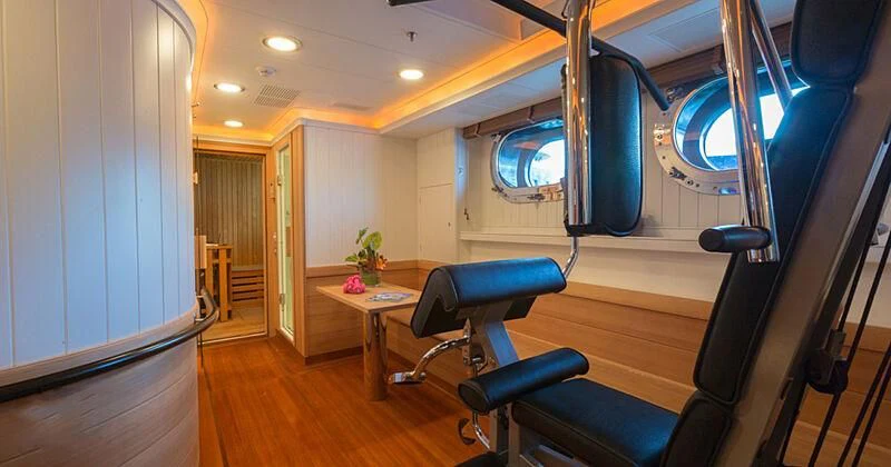 a room with a table and chairs aboard BURRASCA Yacht for Sale