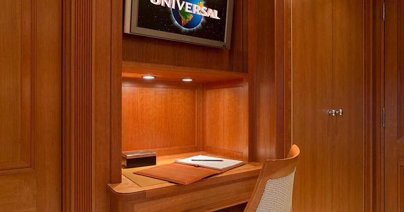 a room with a desk and a tv on the wall aboard BURRASCA Yacht for Sale