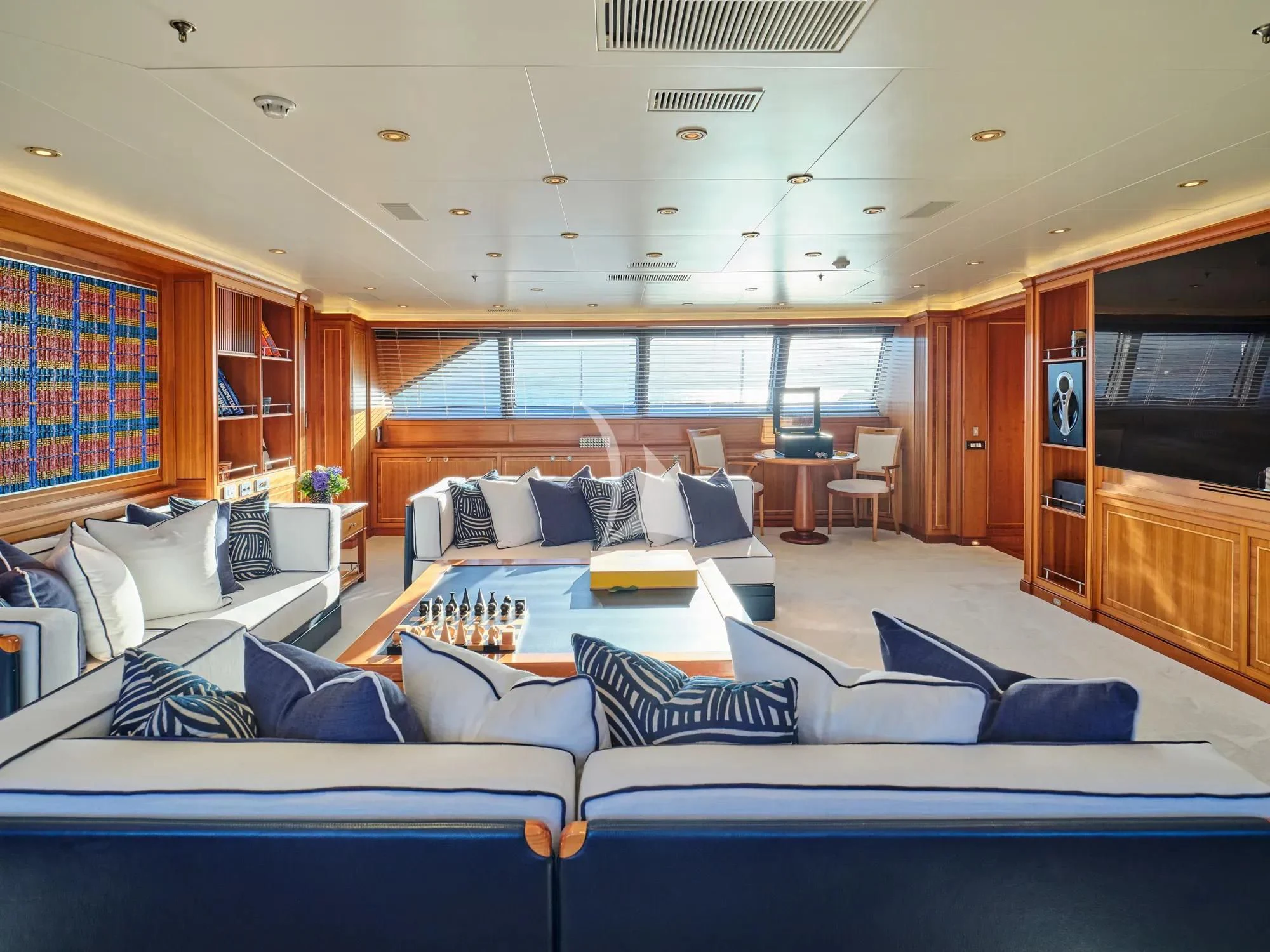 a room with couches and a tv aboard BURRASCA Yacht for Sale
