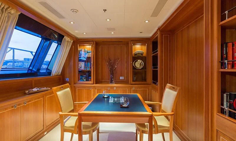 a room with a table and chairs aboard BURRASCA Yacht for Sale