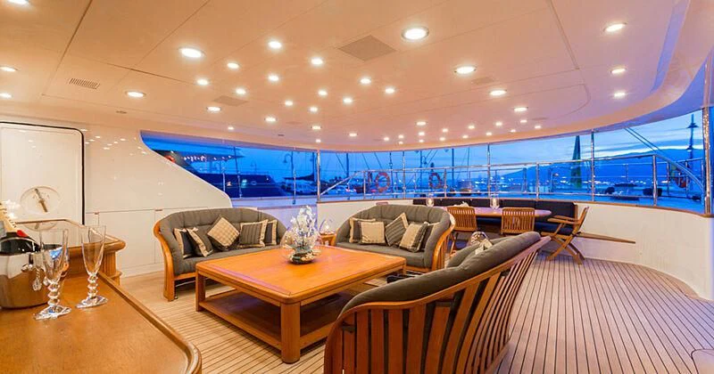 a living room with a table and chairs aboard BURRASCA Yacht for Sale