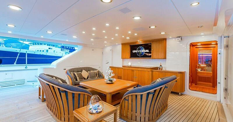 a living room with a table and chairs aboard BURRASCA Yacht for Sale