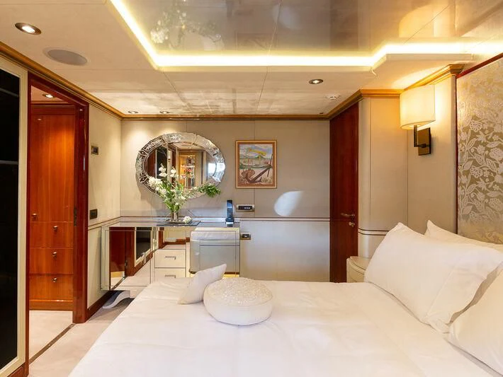 a bed with a white bed spread aboard IL SOLE Yacht for Sale