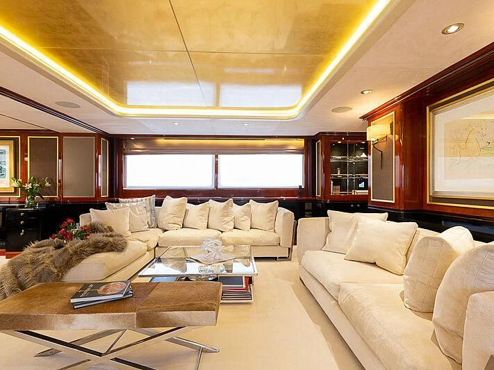 a living room with a couch and a coffee table aboard IL SOLE Yacht for Sale
