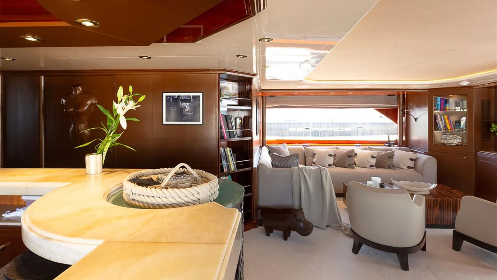 a living room with a large window aboard IL SOLE Yacht for Sale