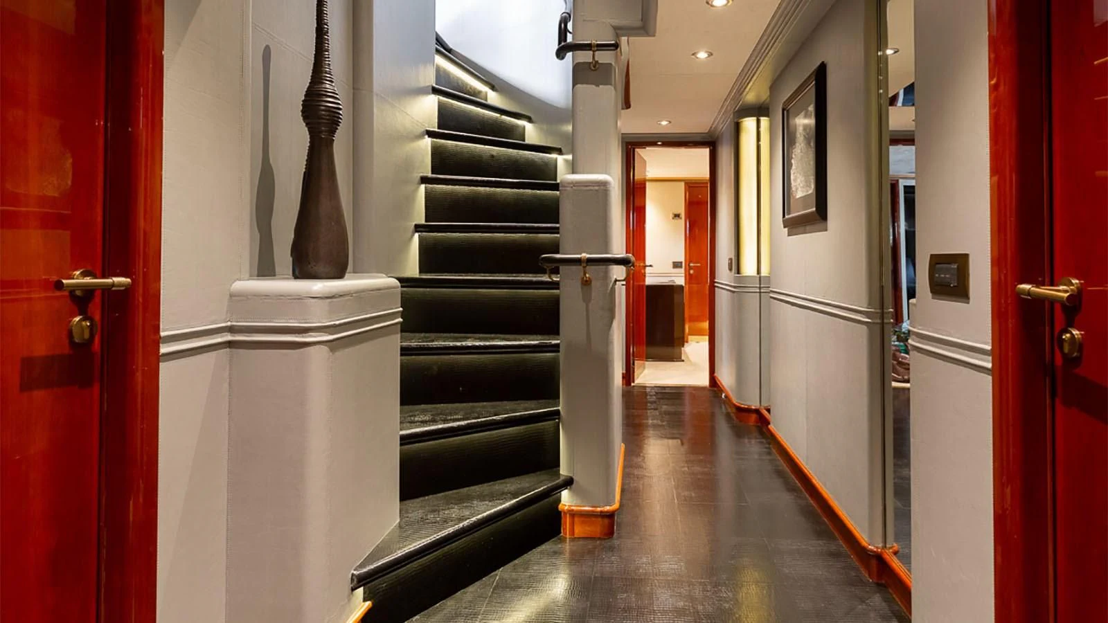 a hallway with red doors aboard IL SOLE Yacht for Sale