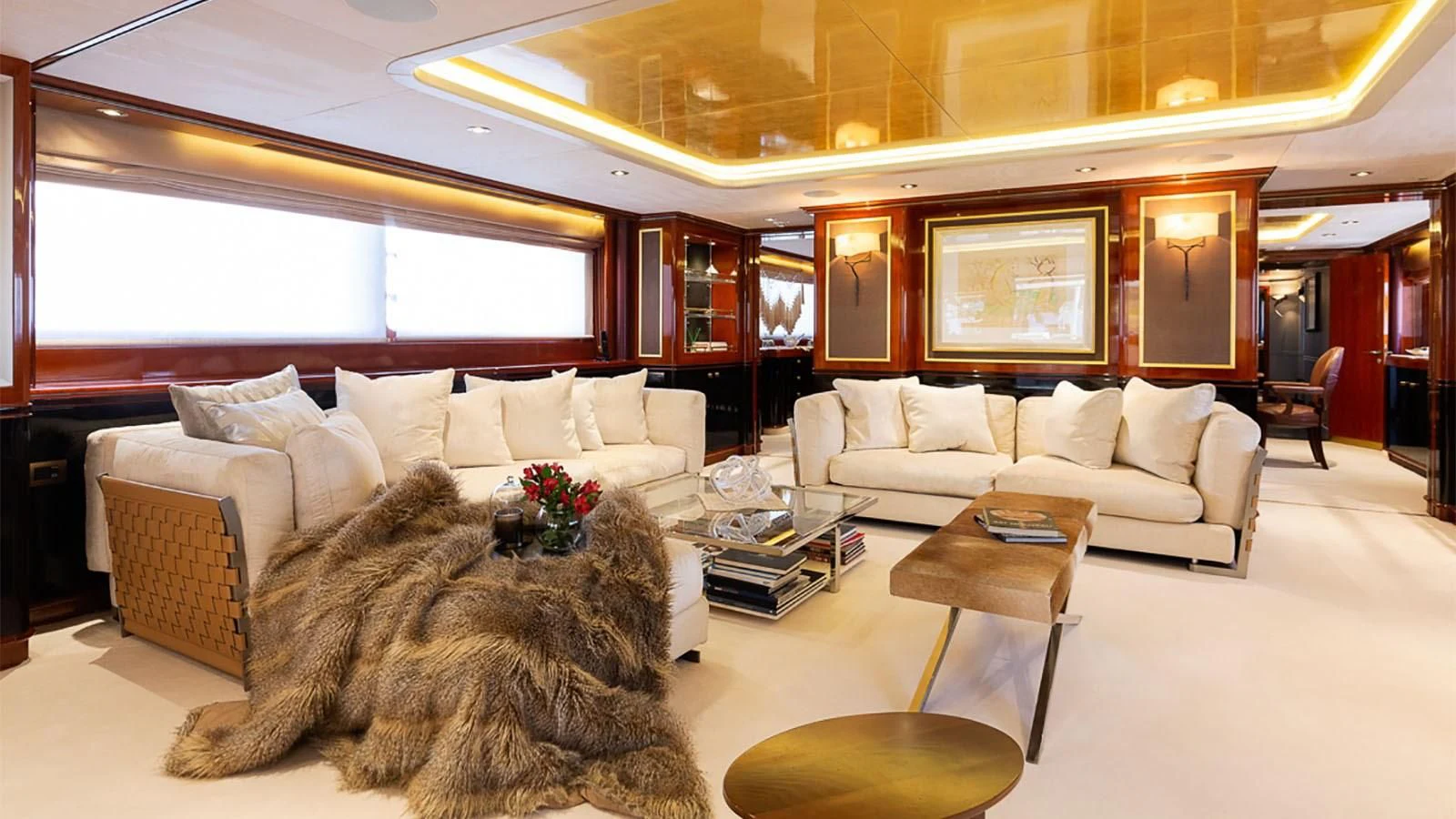 a living room with a large white couch and a large window aboard IL SOLE Yacht for Sale