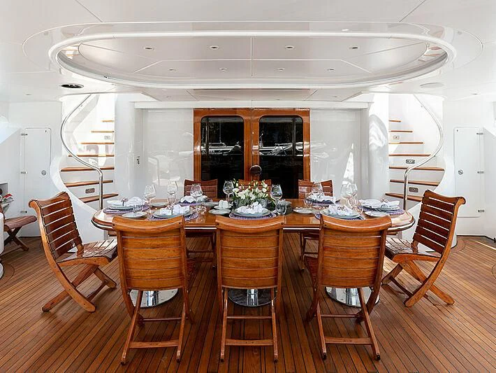 a dining room with a table and chairs aboard IL SOLE Yacht for Sale