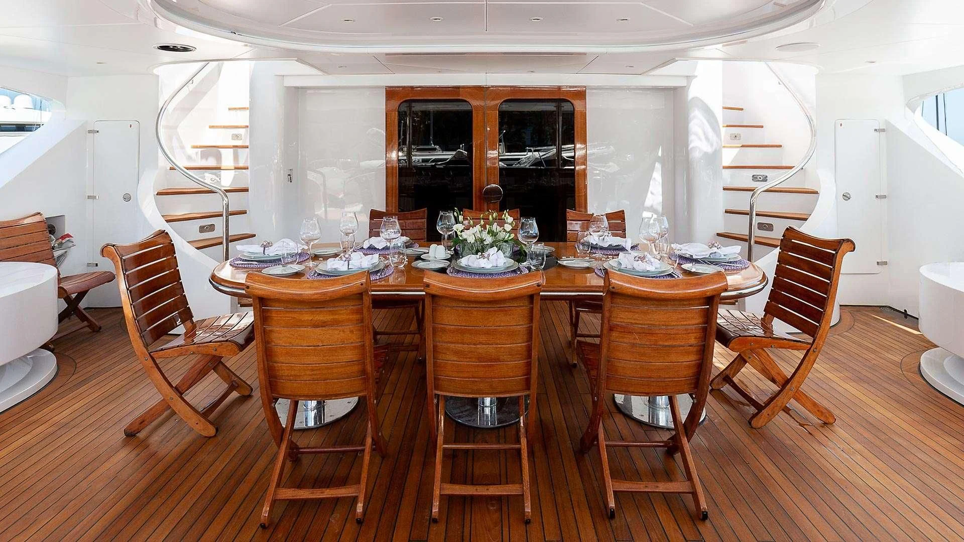 a dining room with chairs and a table aboard IL SOLE Yacht for Sale