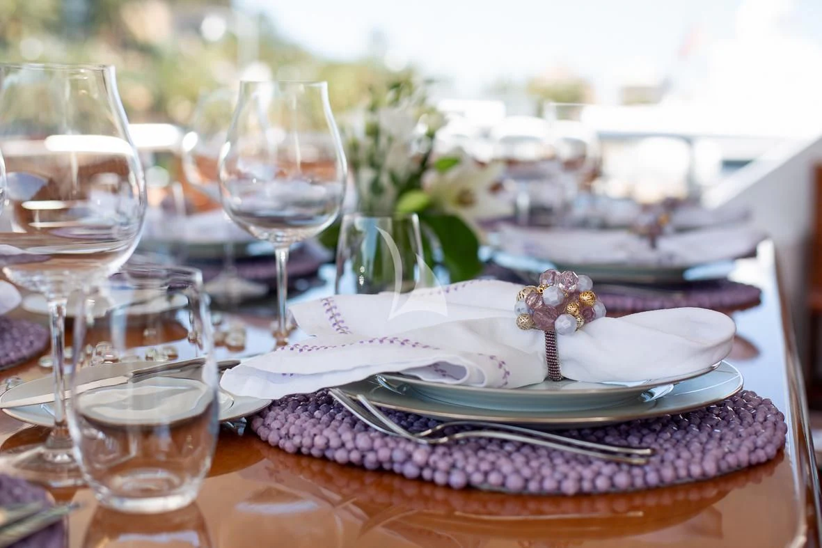 a table with plates and glasses aboard IL SOLE Yacht for Sale