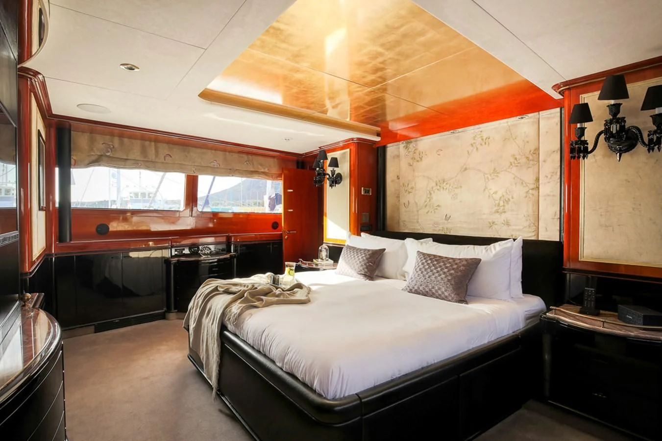 a room with a bed and a window aboard IL SOLE Yacht for Sale
