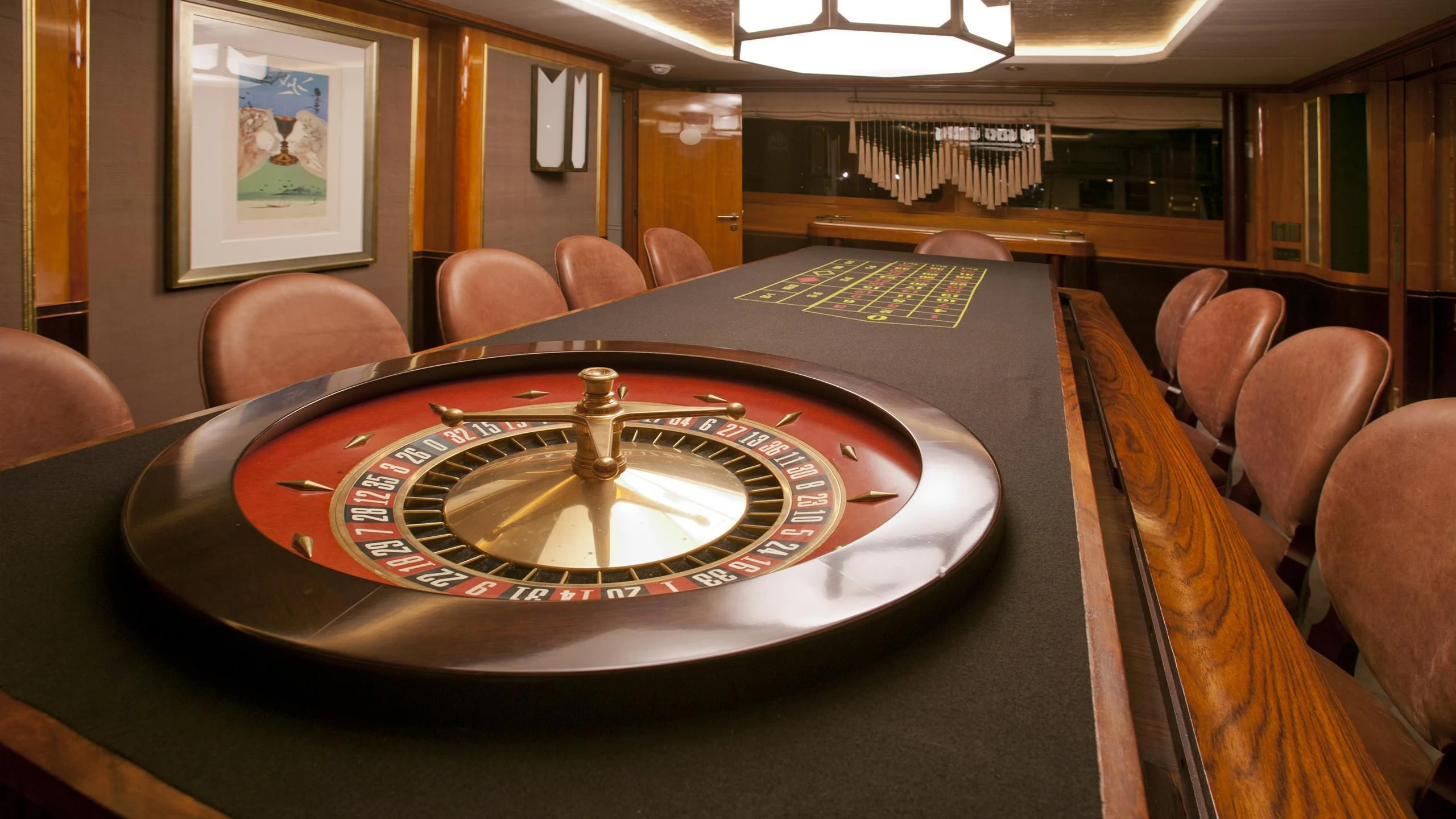 a large round table with a gold plate and a gold cup on it aboard IL SOLE Yacht for Sale