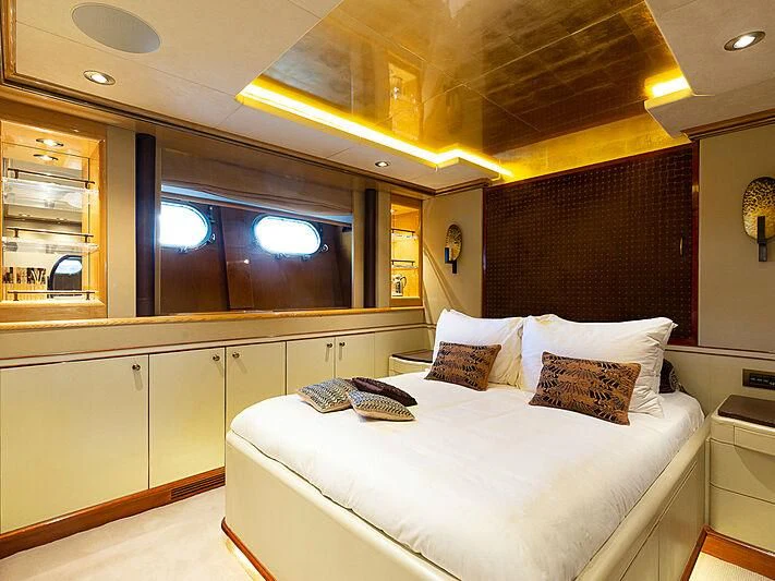 a room with a bed and a television aboard IL SOLE Yacht for Sale