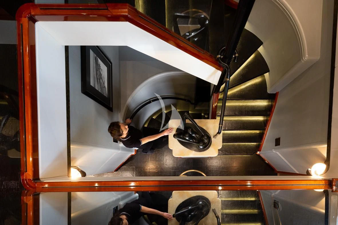 a person standing in front of a large mirror aboard IL SOLE Yacht for Sale