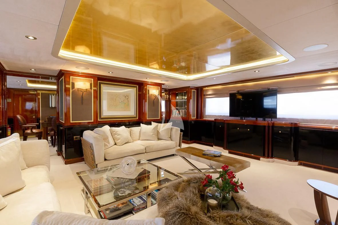 a living room with a large screen aboard IL SOLE Yacht for Sale