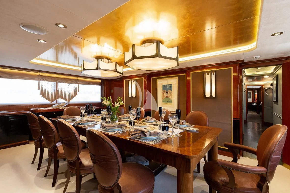 a dining room with a table and chairs aboard IL SOLE Yacht for Sale