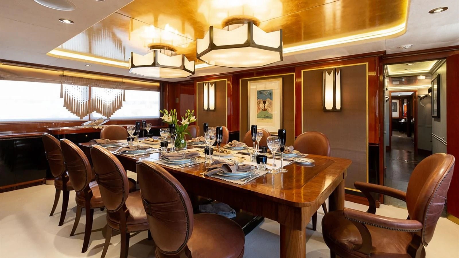 a dining room with a table set aboard IL SOLE Yacht for Sale