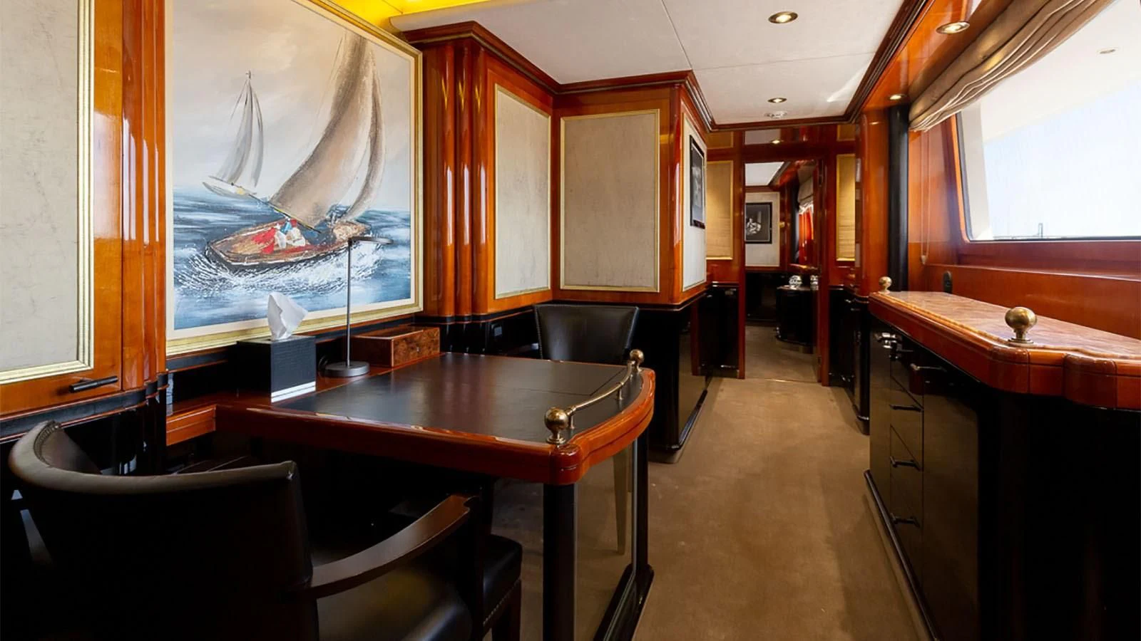a room with a table and chairs aboard IL SOLE Yacht for Sale