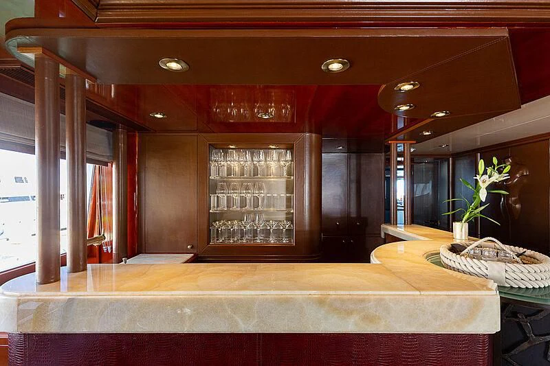 a bar with a table and glasses aboard IL SOLE Yacht for Sale