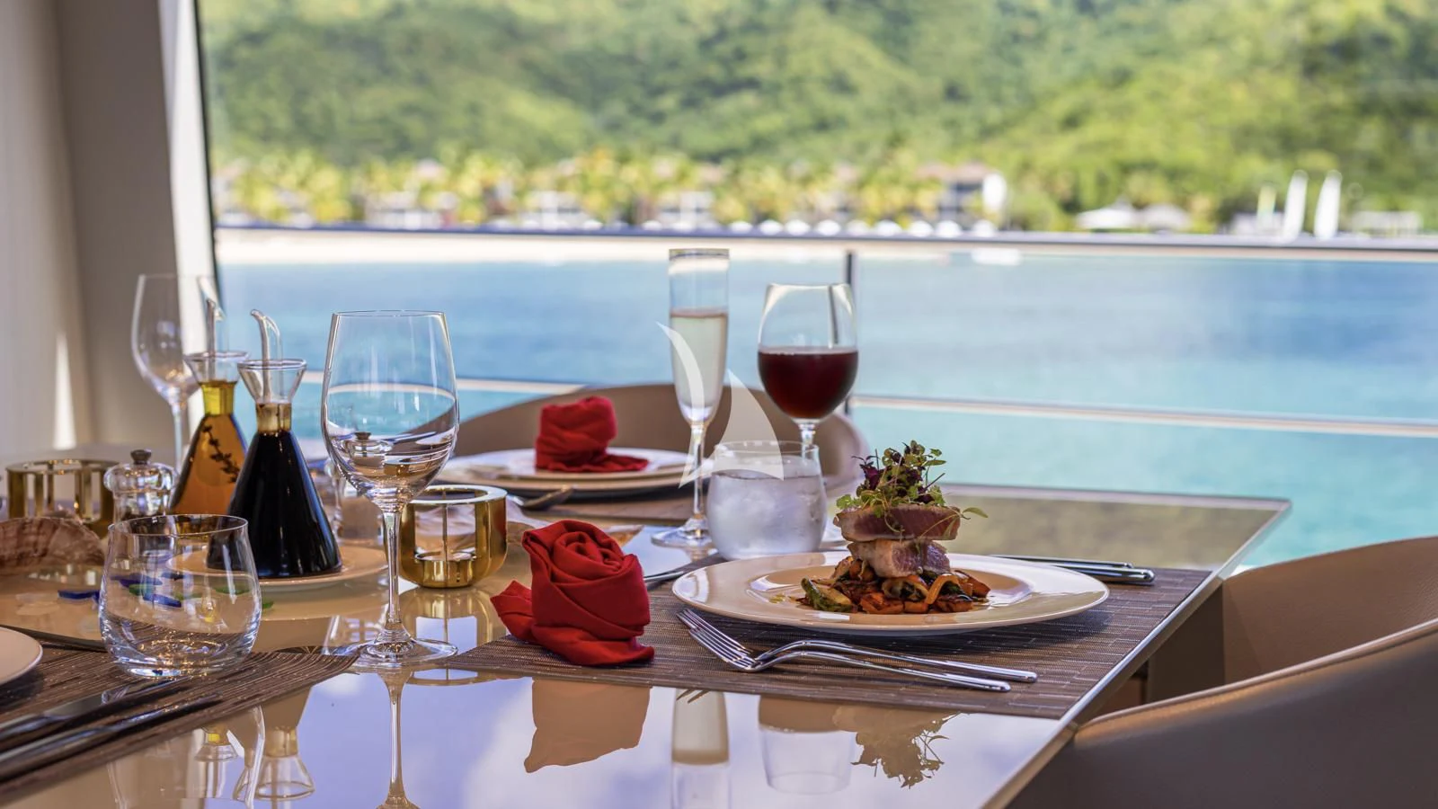 a table with food and wine glasses on it aboard SQUALO Yacht for Sale