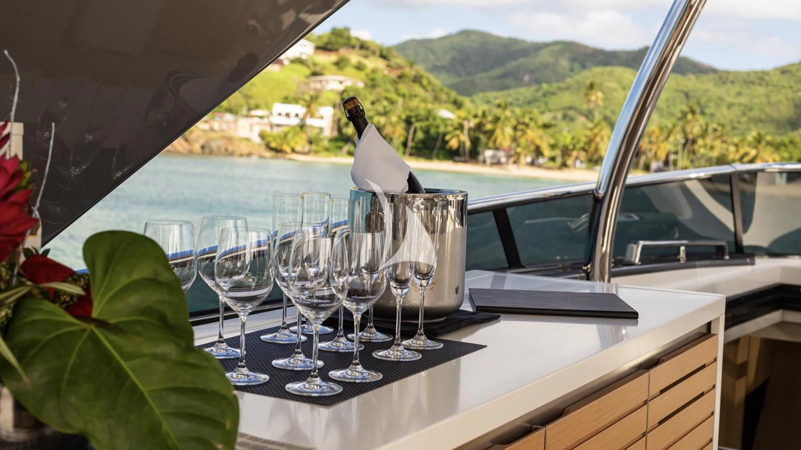 a table with wine glasses and a bird on it aboard SQUALO Yacht for Sale