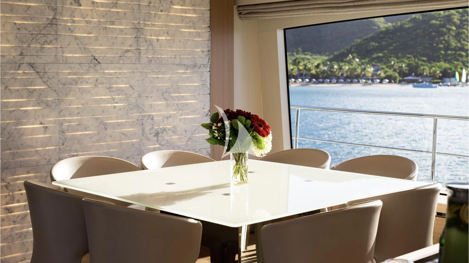 a table with flowers on it aboard SQUALO Yacht for Sale
