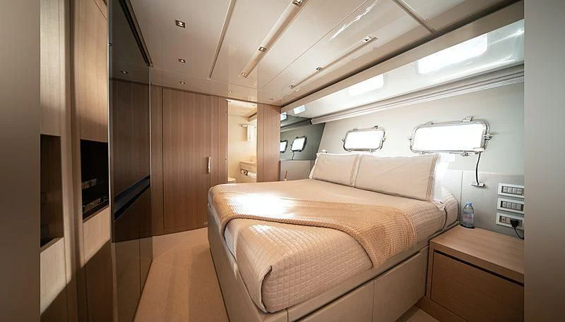a room with a bed and a desk aboard SQUALO Yacht for Sale