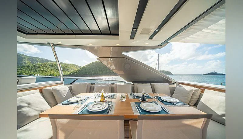 a table with plates and chairs on it aboard SQUALO Yacht for Sale