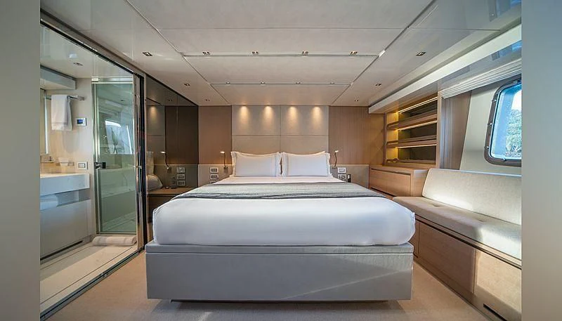 a room with a bed and a glass door aboard SQUALO Yacht for Sale