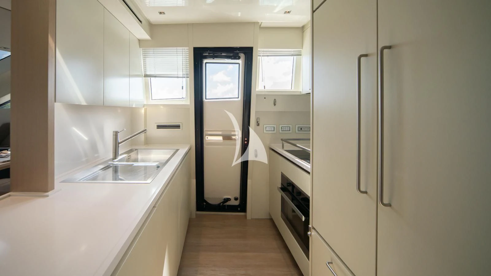 a kitchen with a refrigerator and sink aboard SQUALO Yacht for Sale