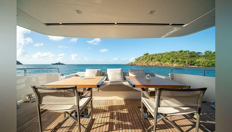 a room with a table and chairs aboard SQUALO Yacht for Sale