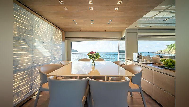 a kitchen with a table and chairs aboard SQUALO Yacht for Sale