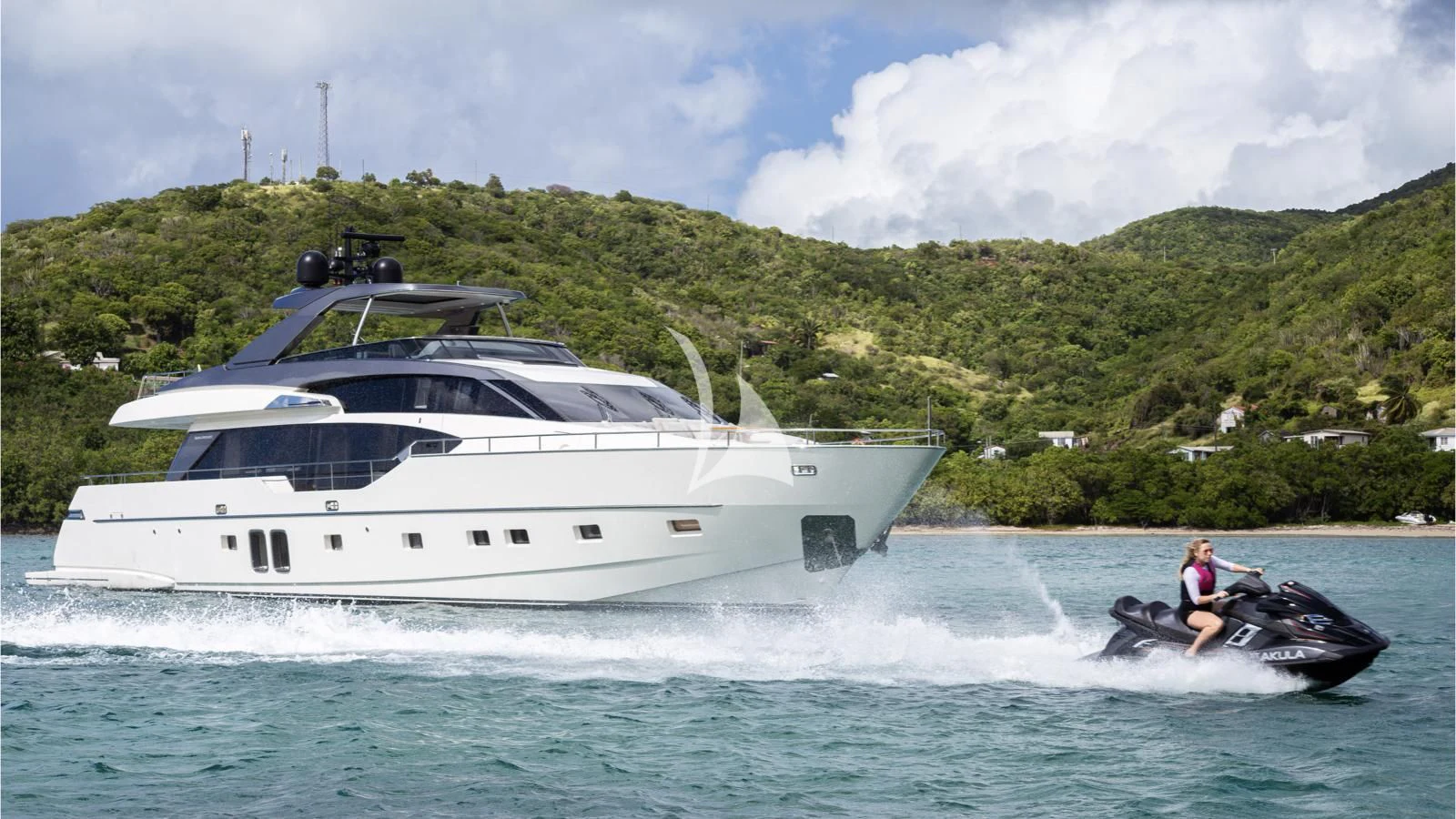 a person on a jet ski in the water next to a boat aboard SQUALO Yacht for Sale