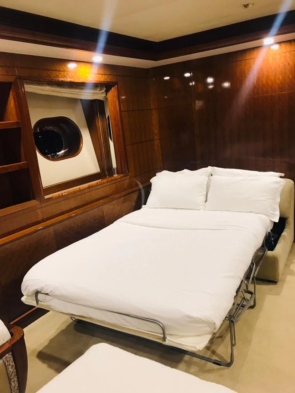 a bed with a mirror above it aboard ASHENA Yacht for Charter
