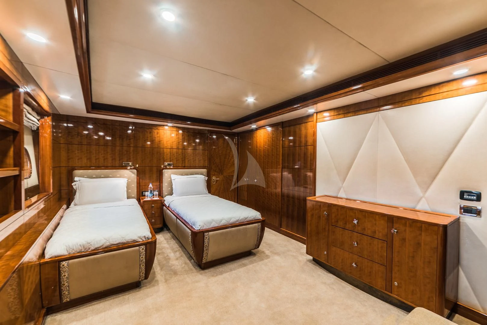 a room with a bed and a dresser aboard ASHENA Yacht for Charter