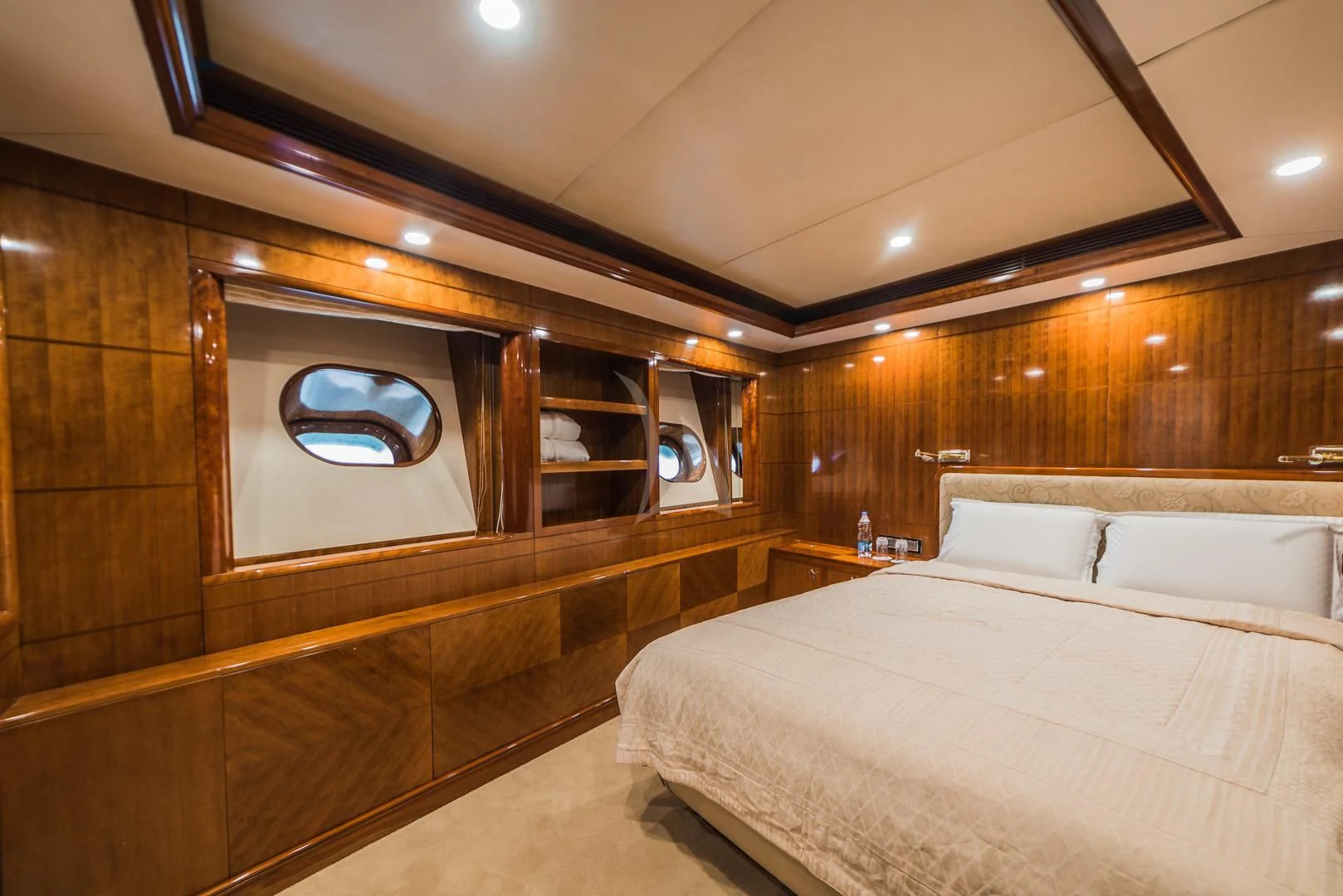 a room with a bed and a mirror aboard ASHENA Yacht for Charter