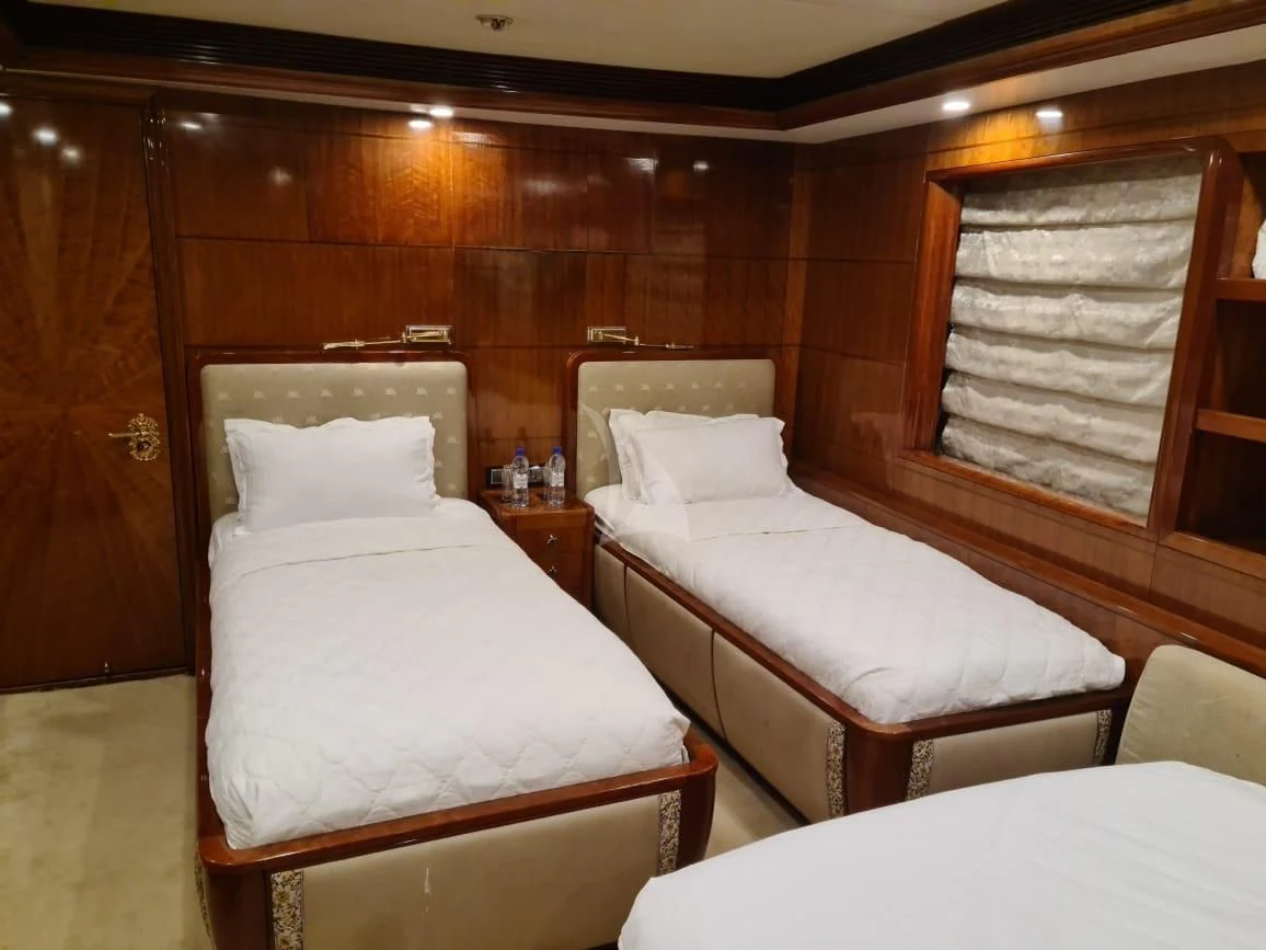 a room with two beds aboard ASHENA Yacht for Charter
