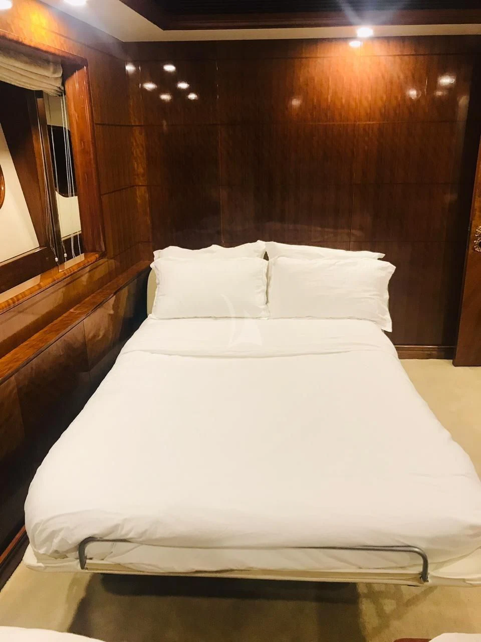 a bed with white sheets aboard ASHENA Yacht for Charter