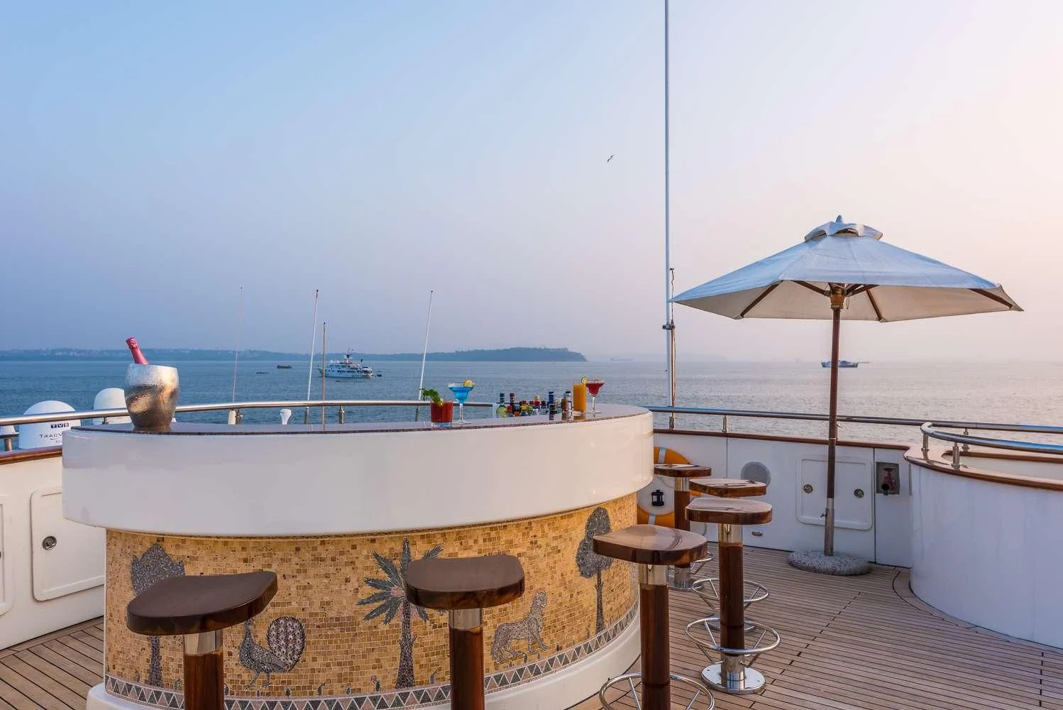 a room with a table and chairs and umbrellas aboard ASHENA Yacht for Charter