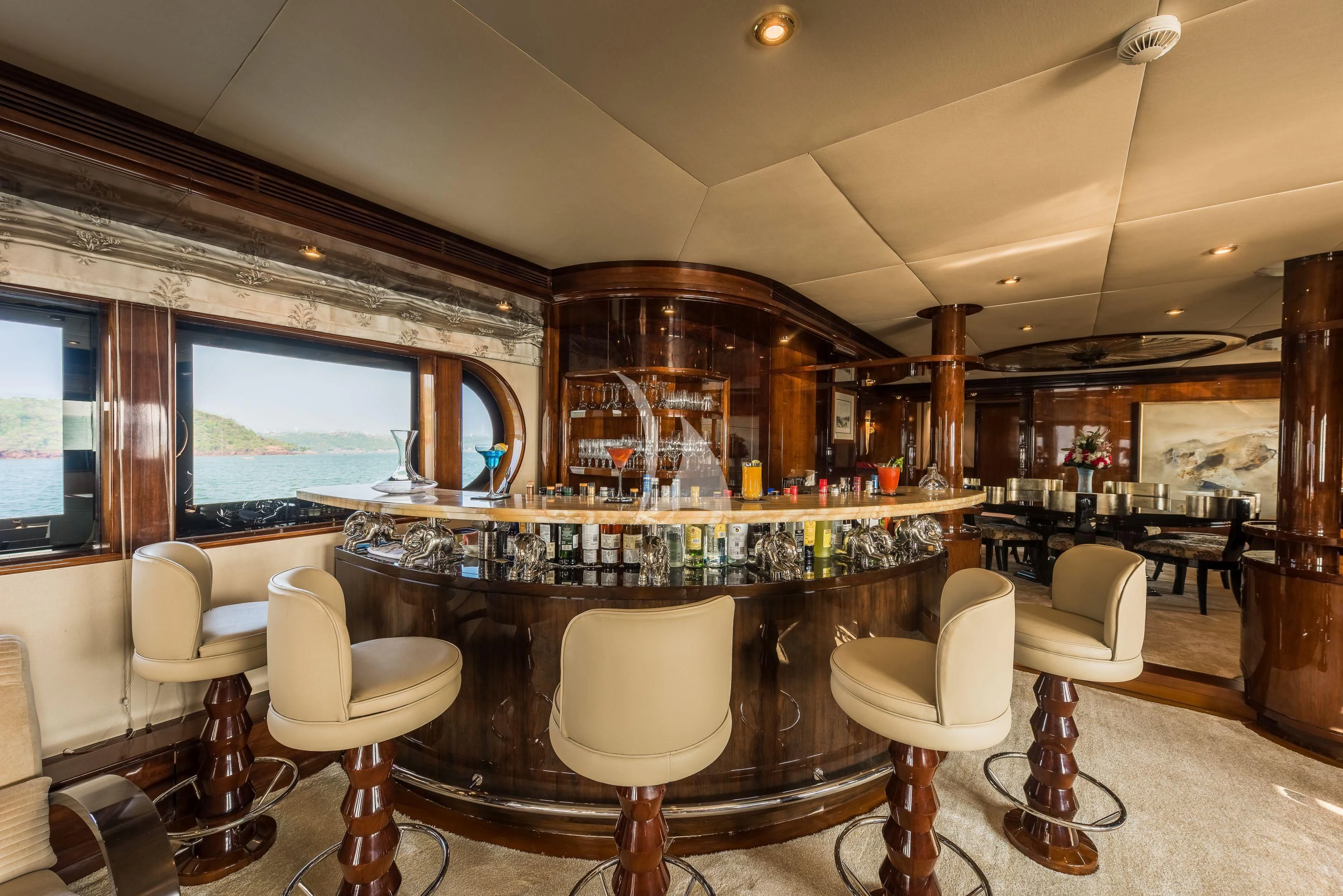 a bar with a bar and chairs aboard ASHENA Yacht for Charter