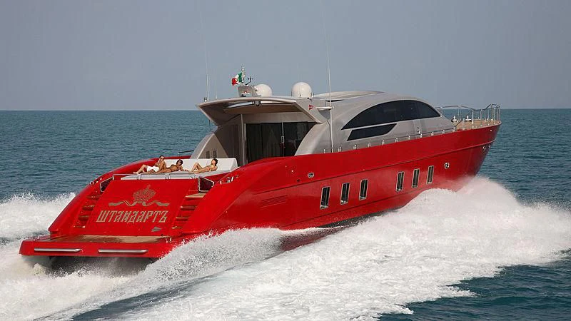 a red boat on water aboard STANDARTE Yacht for Sale