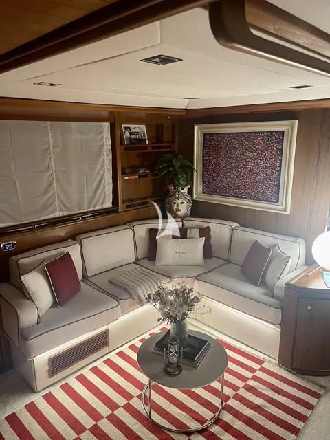 a living room with a white couch aboard MALIZIA Yacht for Sale