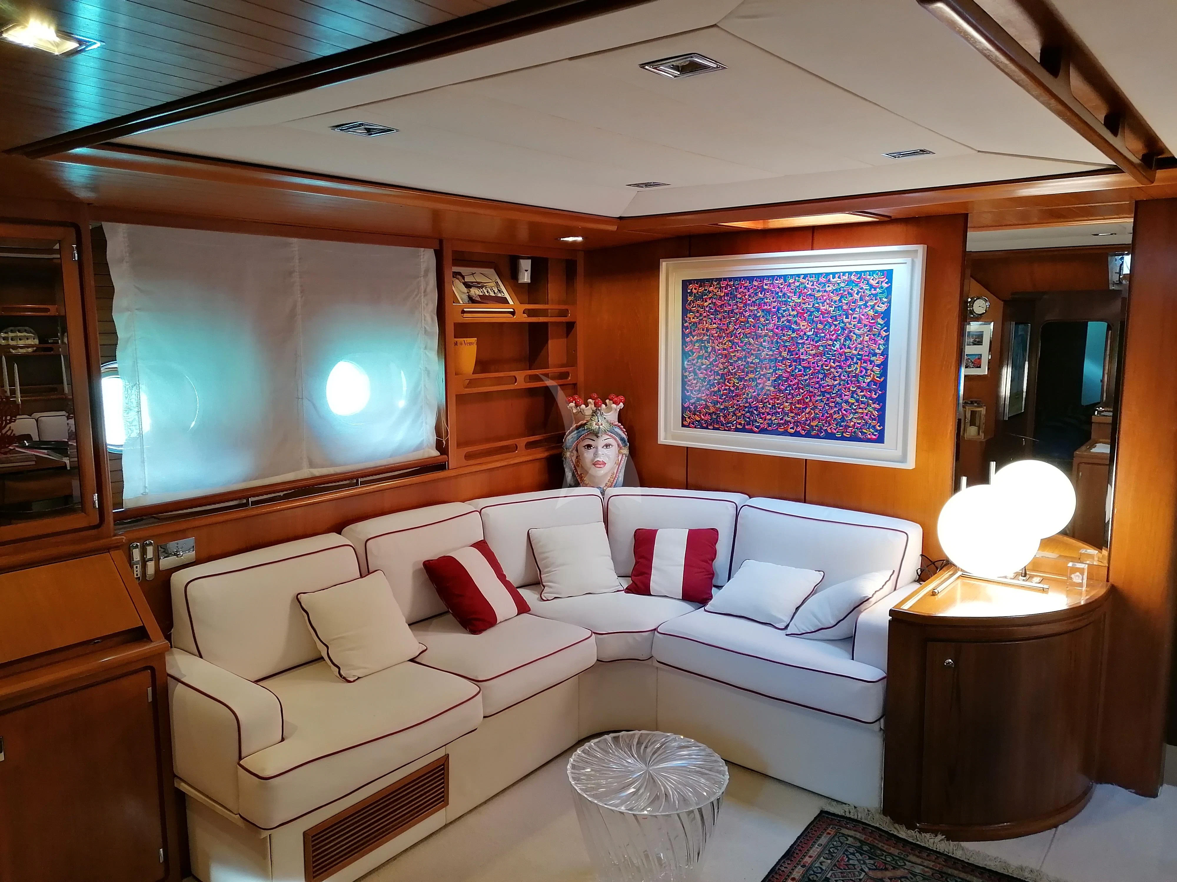 a living room with a large screen aboard MALIZIA Yacht for Sale