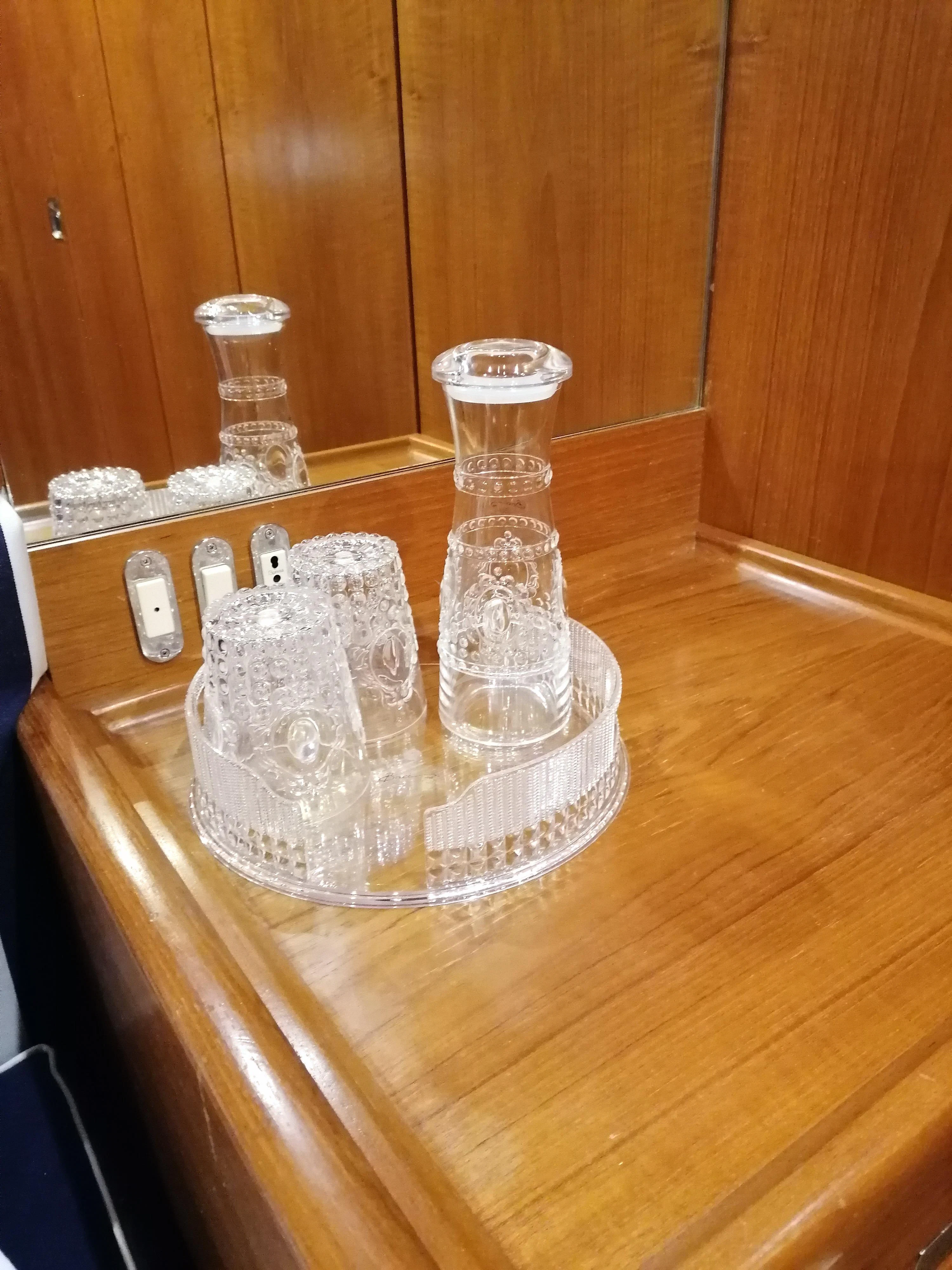 a glass and salt shaker on a table aboard MALIZIA Yacht for Sale