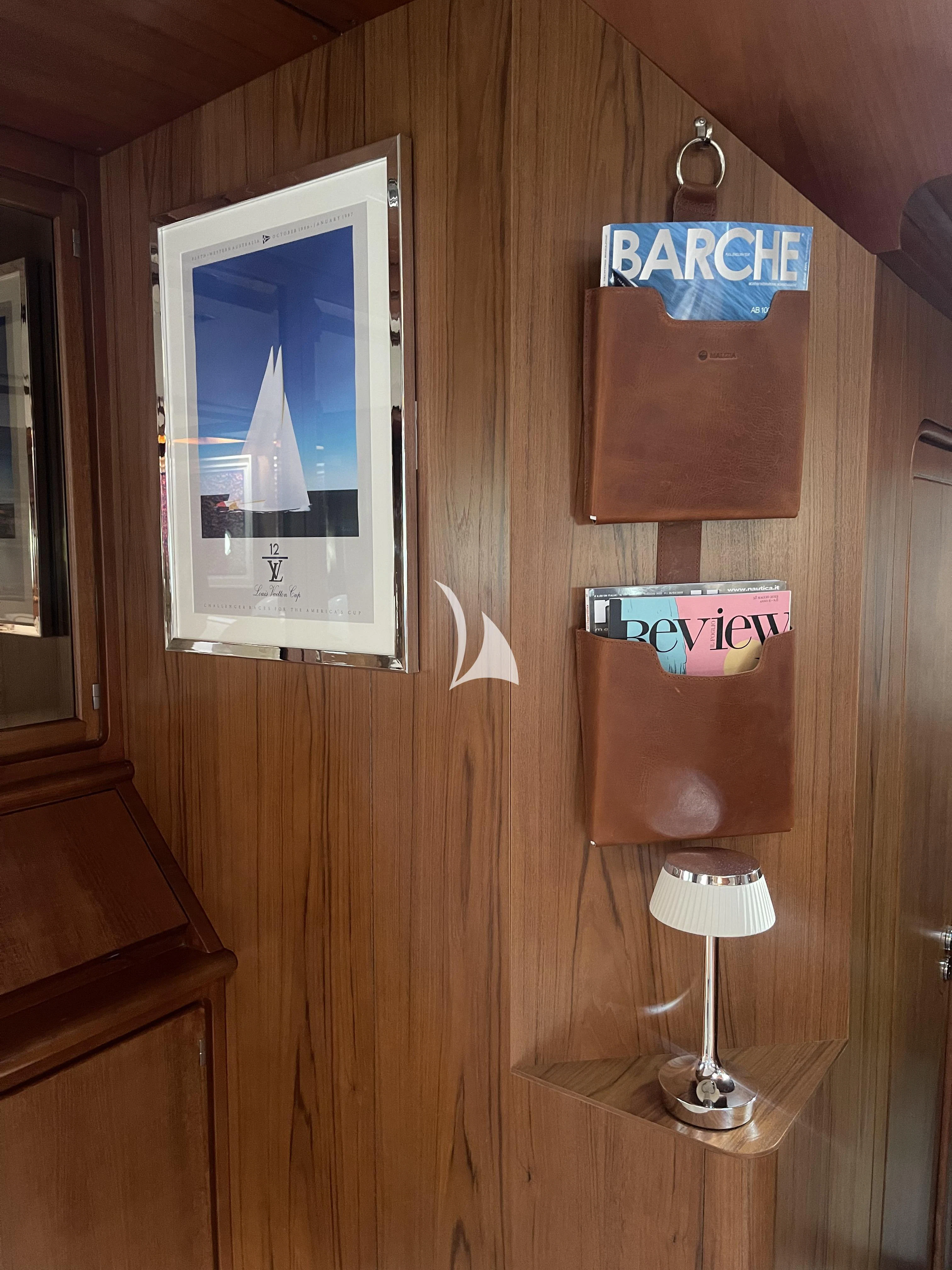 a wood wall with a sign and a lamp on it aboard MALIZIA Yacht for Sale