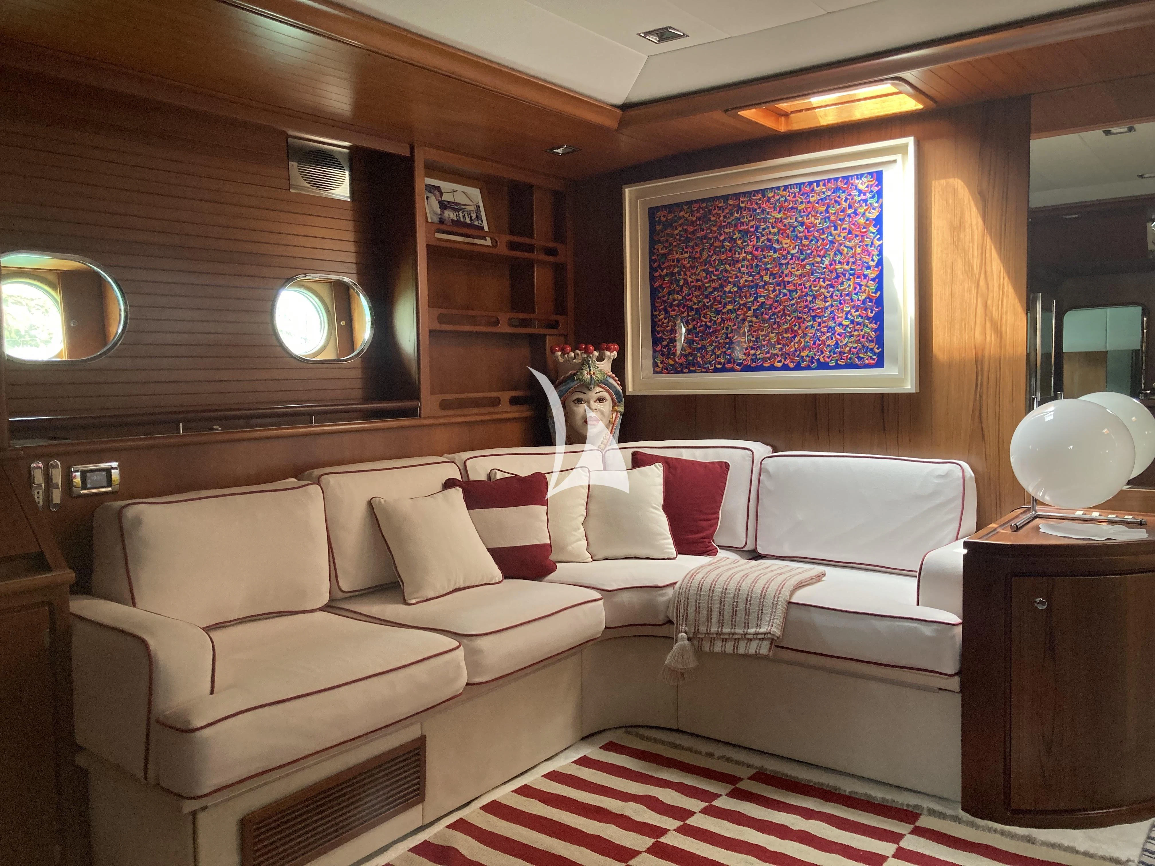 a person sitting on a couch aboard MALIZIA Yacht for Sale